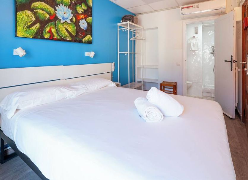 Forum Tarragona in Tarragona guest room with double bed, artwork, and private bathroom door