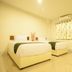 Rinlada House Chiang Rai guest room with two single beds and window curtain