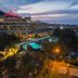 Kaya Izmir Thermal & Convention in Izmir with illuminated pool, terrace seating and city skyline at dusk