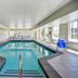Indoor pool at Homewood Suites by Hilton Salt Lake City Airport with hot tub and large windows