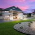 The Hotel Saratoga in Saratoga Springs exterior with landscaped entrance and sunset sky