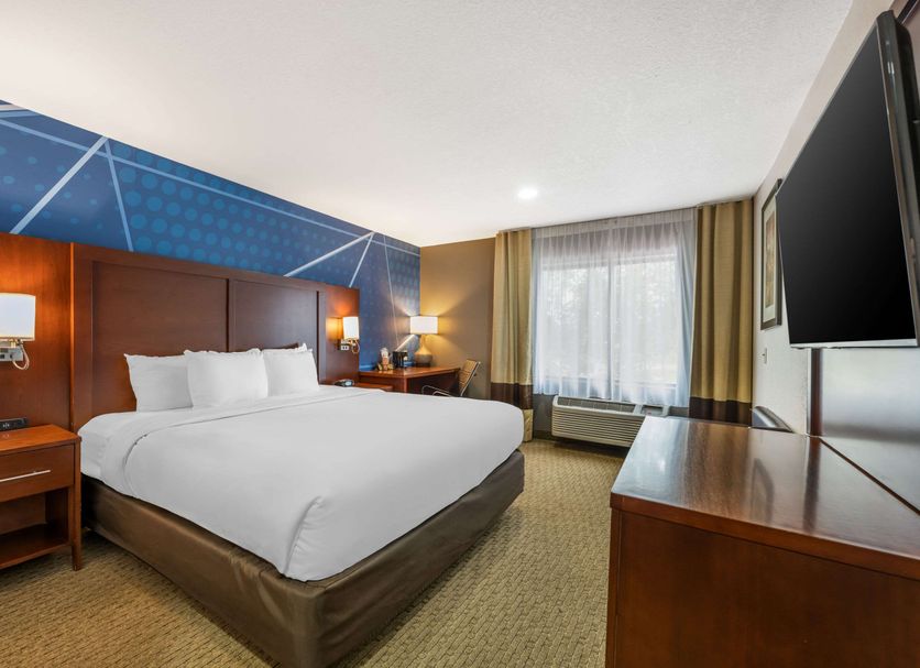 Comfort Suites Omaha East-Council Bluffs room with king bed, desk, TV and window in Council Bluffs