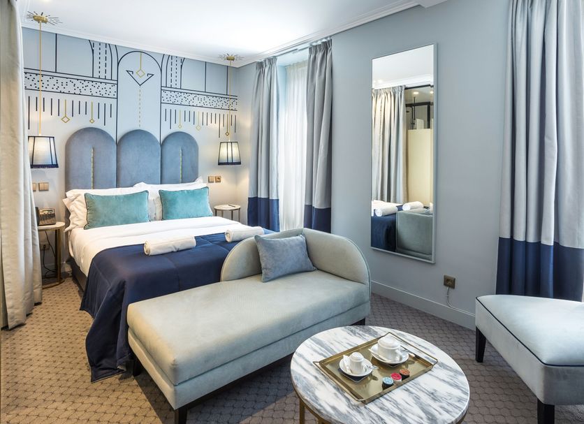 The Lift Boutique Hotel by Ridan Hotels Lisbon room with bed, chaise lounge and patterned headboard