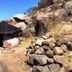 Royal Game Guest House in Phalaborwa, rustic rondavel hut beside rocky hillside under clear blue sky