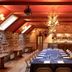 Loch Kinord Hotel in Aboyne, banquet room with long set dining table and stone accent wall