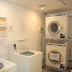 Laundry room at Smile Hotel Kumagaya in Kumagaya with washers, dryers, and posted instructions