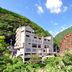Hotel Obokekyo Mannaka in Miyoshi beside a red bridge and lush green mountain valley