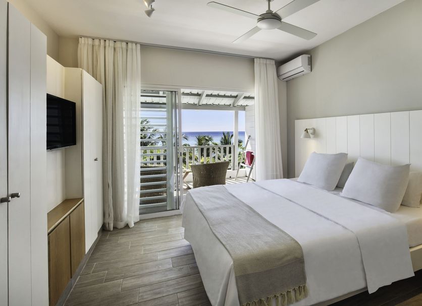 The Bay, Grande Rivière Noire hotel room with king bed and balcony view to the sea