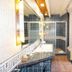 Hotel Plaça in Sant Feliu de Guíxols bathroom with tiled shower, vanity sink and stone countertop
