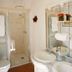 La Demeure Saint-Ours bathroom with shower, double sinks, and exposed wooden beams in Loches