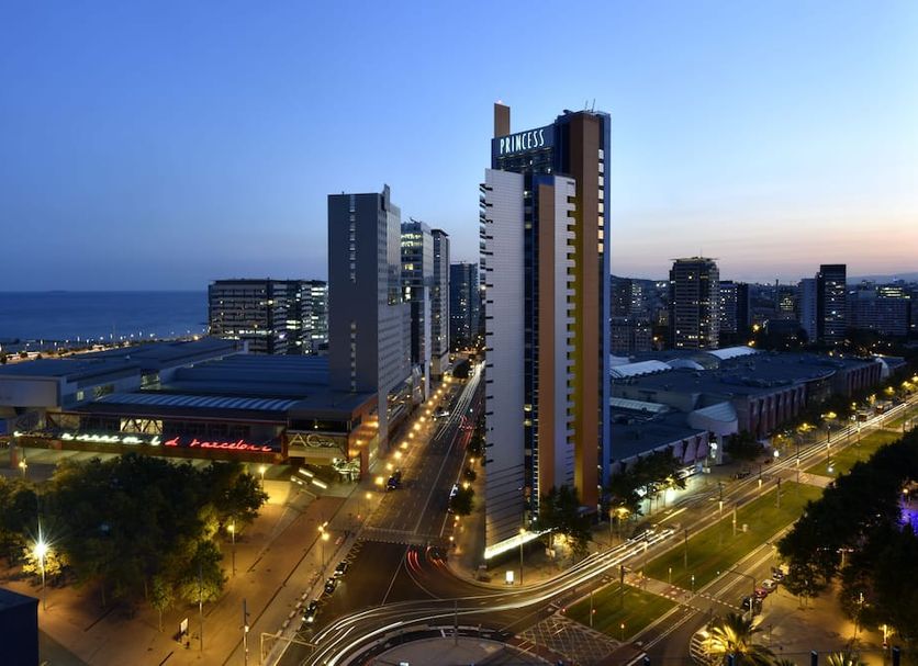 Barcelona Princess hotel in Barcelona skyline view at dusk with city streets and sea in the background
