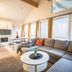 Tromsø Lodge & Camping, Tromsø: bright cabin lounge with sectional sofa, kitchen, and large windows