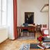 Living Hotel an der Oper in Vienna room with desk, TV, sofa, bed, and parquet floor