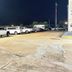 Americas Best Value Inn & Suites Senatobia parking lot with several parked vehicles at night