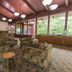Carter Caves State Resort lounge in Olive Hill with patterned armchairs, stone fireplace and large windows