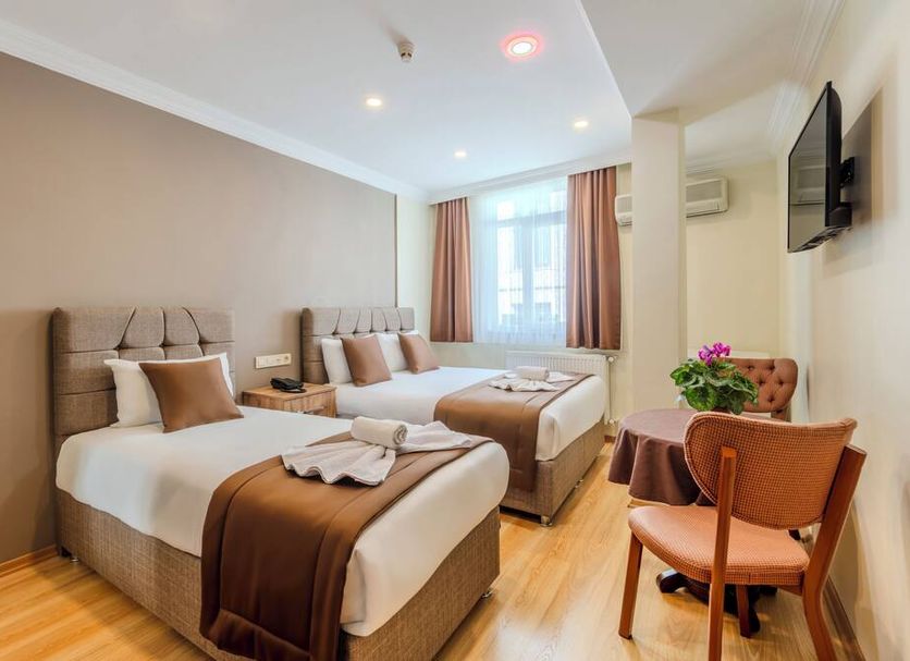 Hotel Silviya Istanbul guest room with two twin beds, window light and wall-mounted TV
