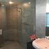 Sunshine Airport Hotel in Zhuhai bathroom with glass-enclosed walk-in shower and pink flower decor