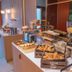 Breakfast buffet at Bhoma Bourges - Hôtel in Bourges with pastries, bread, cereal dispensers, and coffee station