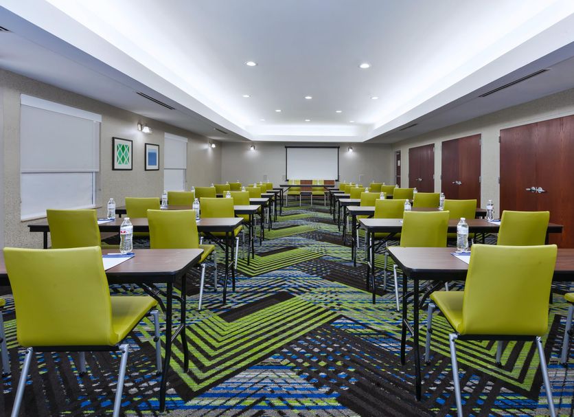 Holiday Inn Express & Suites Dayton South Franklin meeting room with green chairs and arranged tables in Franklin