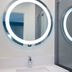 Tilbury Inn Glendale bathroom with illuminated round mirror, sink and glass shower door