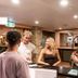 Aquarius Backpackers Resort Byron Bay lobby with guests at the reception desk and lounge seating
