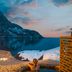 Nusfjord Village & Resort in Ramberg with oceanfront deck, snowy shoreline, and mountain fjord view