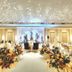 The Palace Hotel Kota Kinabalu ballroom set for a banquet with floral centerpieces and crystal ceiling lights