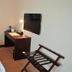 Qilu International Hotel Harbin room with bed, wall-mounted TV, desk lamp and luggage rack