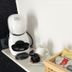Vingt Sept in Polignano a Mare room with coffee machine, cups, and tea assortment on a shelf