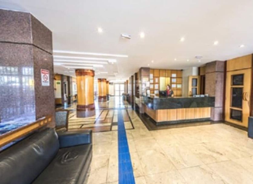 Monumental Bittar Hotel, Brasilia: hotel lobby with front desk, seating, and marble tile floor