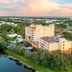 Vacation Village at Bonaventure, Weston, with resort buildings, pool, and scenic lake view