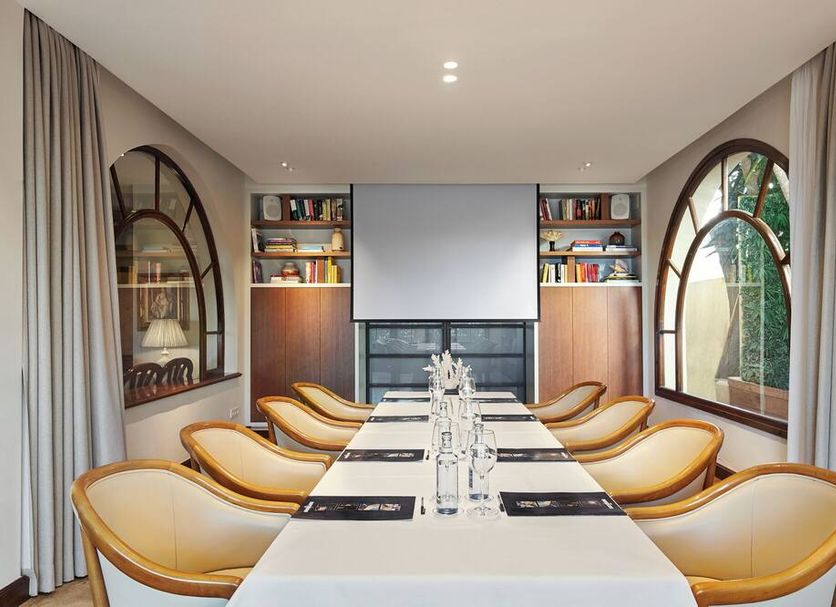 Hotel restaurant Ceferino meeting room with long table, yellow chairs, arched windows in Vilanova i la Geltrú