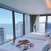 Marianne Hotel Busan room with twin beds and ocean and city views through floor-to-ceiling windows