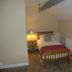 The Kings Head in Meifod guest room with a single bed, bedside lamp, and sloped ceiling