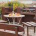 Guest House Mooigezicht in Clarens: outdoor patio with wooden seating and a small table with drinks