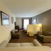 Sonesta Essential Hotels Overland Park guest room with seating area and bed near window