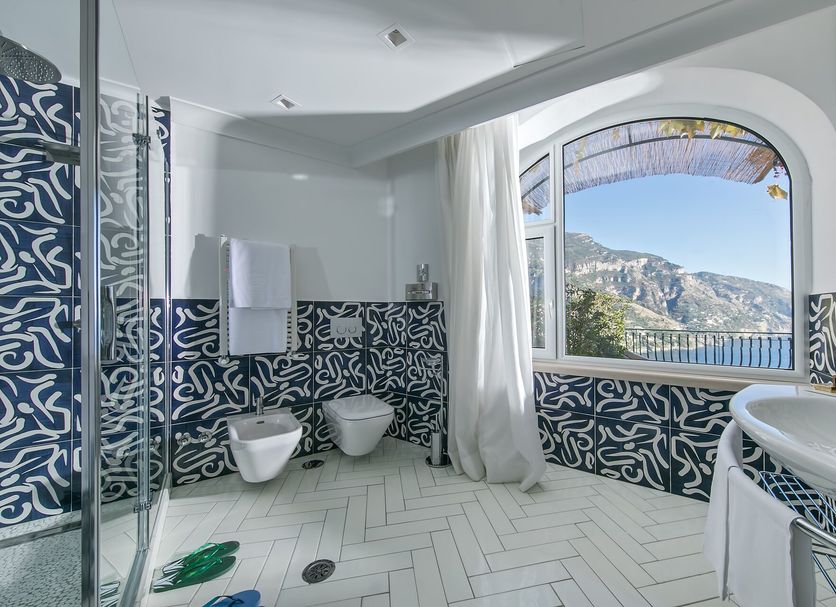Hotel Le Agavi in Positano bathroom with sea-view window and herringbone tile shower
