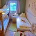 Pension Göschlberger in Mondsee, a simple guest room with bunk beds, twin bed, and window view.