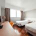 Caritas Oswald Cheung International House Hong Kong twin guest room with window and wood floor