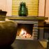 Huerta Real Mazamitla in Mazamitla, rustic fireplace with decorative pottery and a lit fire