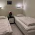 Svea Hostel Stockholm twin room with two single beds, bedside lamp, and small table