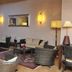 Hotel Ristorante Vecchia Riva in Varese lounge with wicker seating, tables, wall art and warm lamps