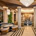 BLESS Hotel Madrid lobby lounge with round seating, marble columns and chandelier in Madrid