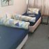 Backpackers Central Hamilton in Hamilton: twin room with four single beds and geometric bedding