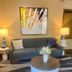 Comfort Inn Rutland-Killington lobby seating area with sofa, lamps, coffee table and abstract wall art