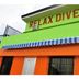 Relax Divers-Pg in Puerto Galera, colorful building facade with striped awning and sign