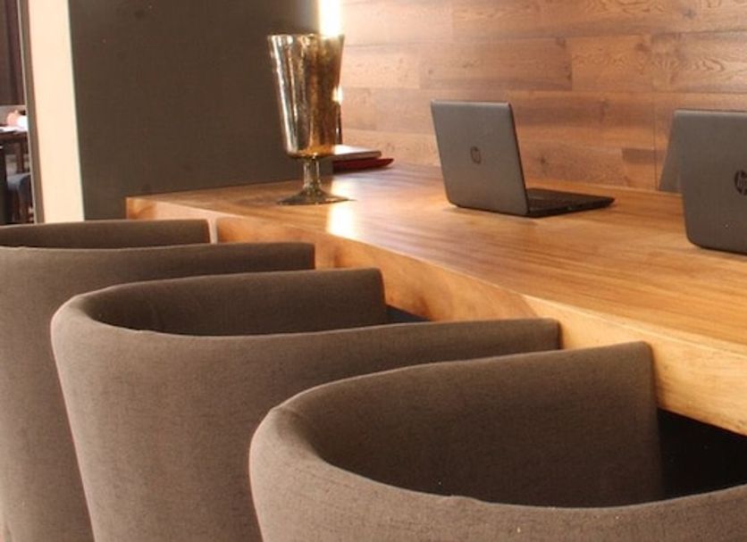 Gran Hotel Concordia in San Luis Potosí lobby with wooden table, laptop, and modern chairs