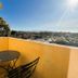 Hotel les Névons in L'Isle-sur-la-Sorgue balcony with table, chairs and sunny town view