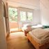 Arena Surf Hotel in Somo guest room with two single beds and open door to a small balcony