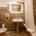 Hotel A.S. Sao Joao da Madeira bathroom with bidet, pedestal sink, mirror, and bathtub in São João da Madeira